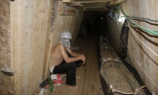 A Palestinian sits in a smuggling tunnel beneath the Egyptian-Gaza border