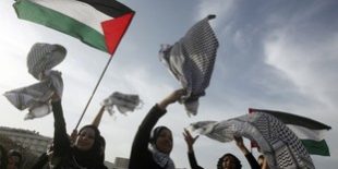 Palestinian women celebrate entering the Guinness Book of World Records for the longest chain of scarves in Beirut