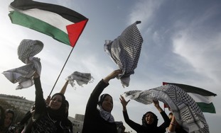Palestinian women celebrate entering the Guinness Book of World Records for the longest chain of scarves in Beirut