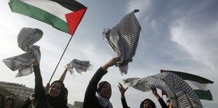Palestinian women celebrate entering the Guinness Book of World Records for the longest chain of scarves in Beirut