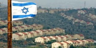 Israeli flag flutters over view of Jewish settlement of Ofra
