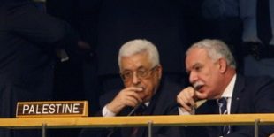 Palestinian President Mahmoud Abbas confers with a member of his staff as he attends the 66th United Nations General Assembly at the U.N. headquarters in New York
